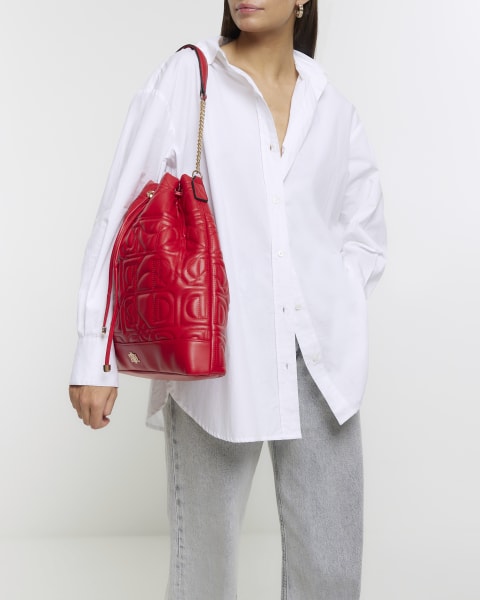 Red quilted drawstring shoulder bag