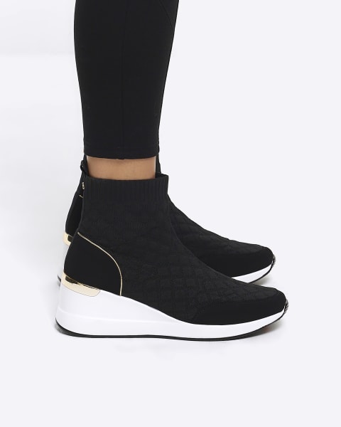 Black quilted wedge trainers