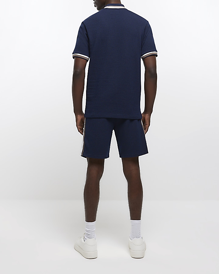Navy slim fit textured taped polo shirt | River Island