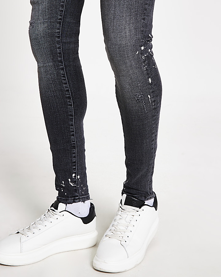 Black paint Ollie spray on skinny jeans