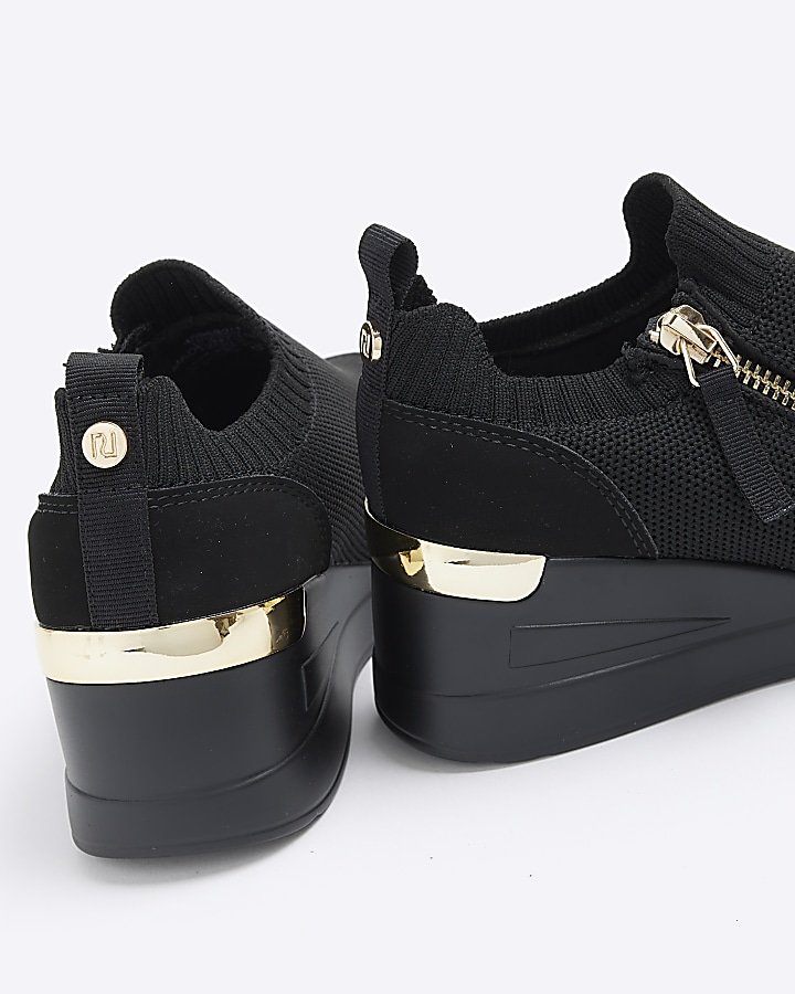Girls black knitted wedge trainers