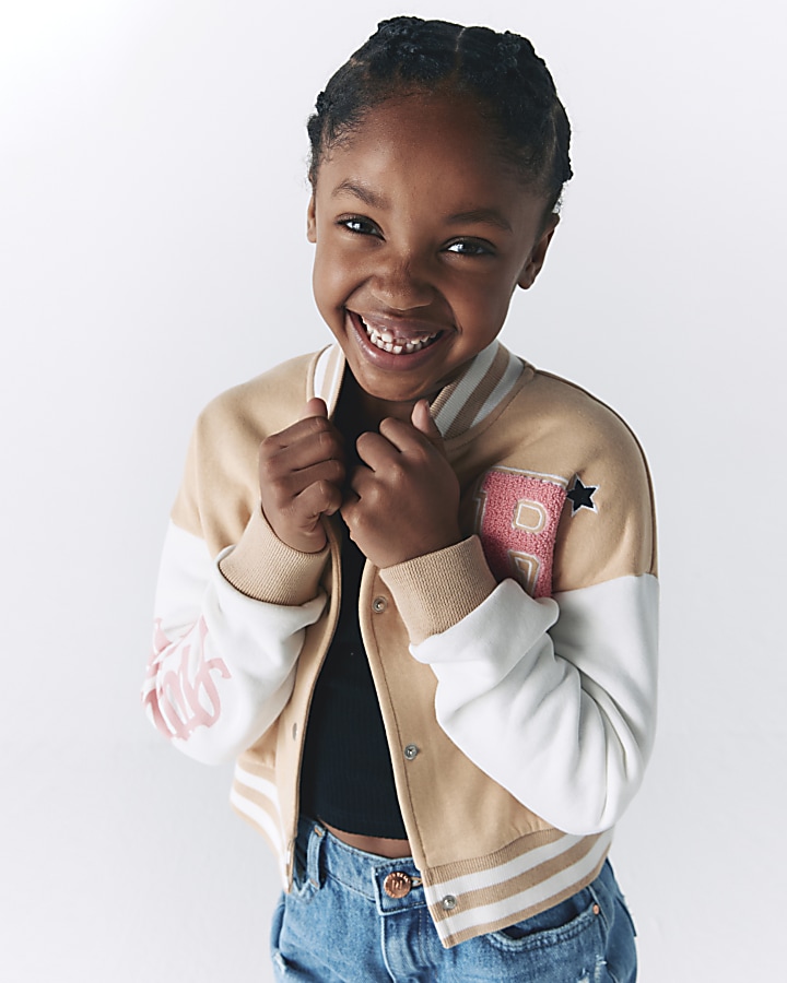 Girl in varsity outlet jacket