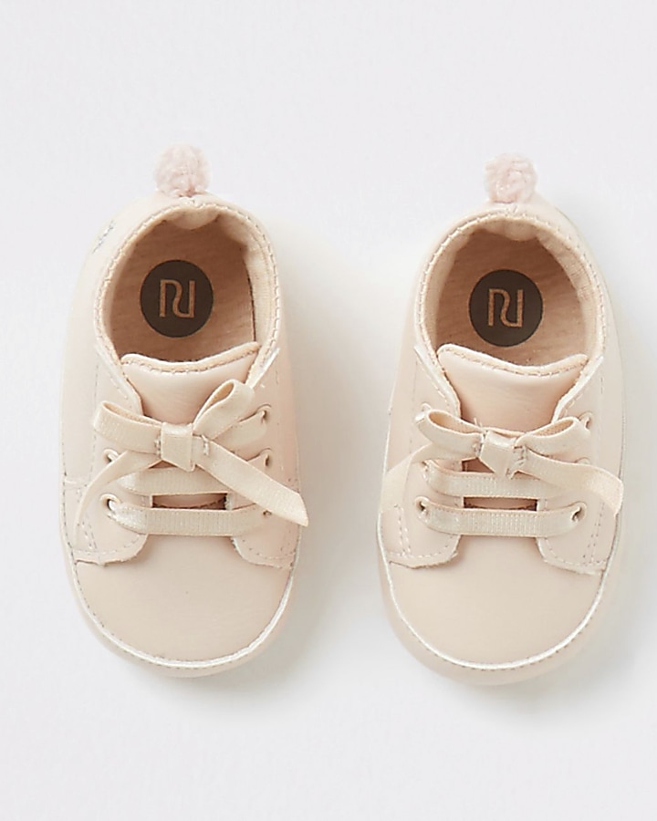 Baby pink pom pom lace-up trainers