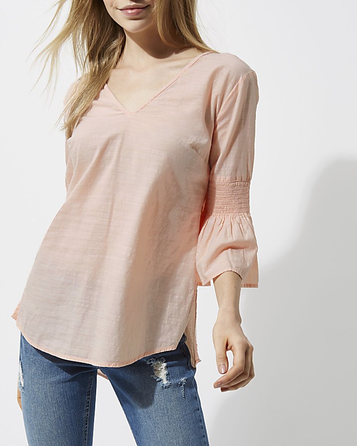 Light pink shirred bell sleeve top
