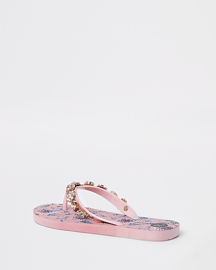 Pink jewel embellished flip flops