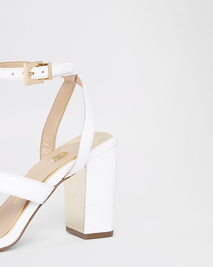 White asymmetric strappy block heel sandals