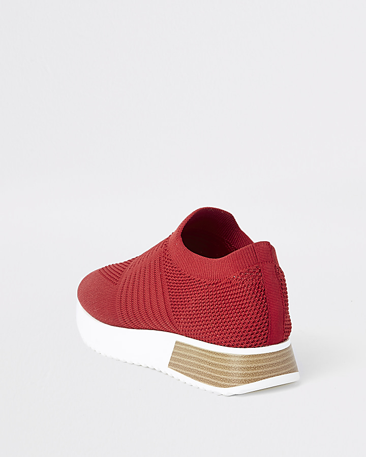 Red knitted runner trainers