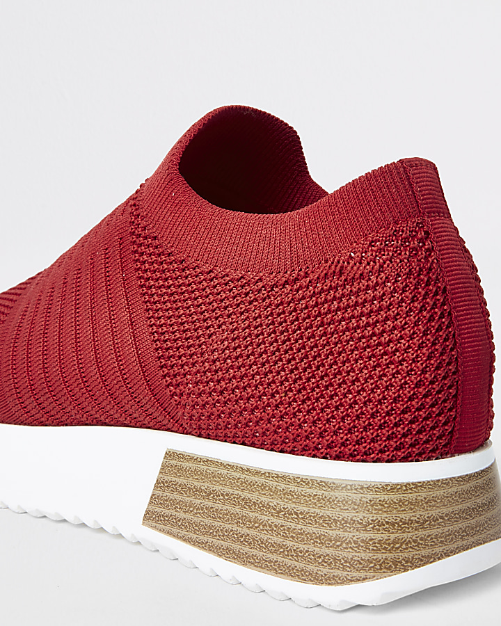 Red knitted runner trainers