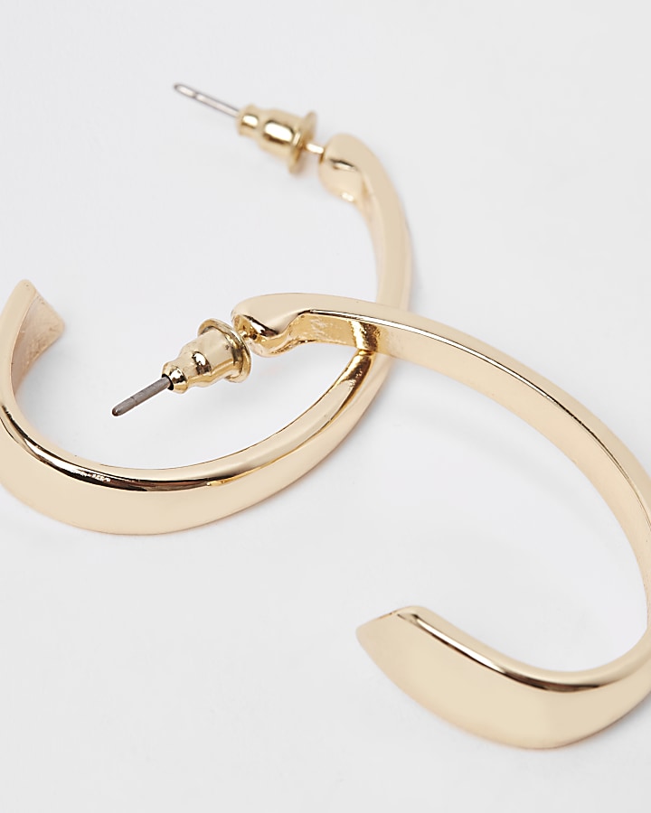 Gold tone small oval hoop earrings