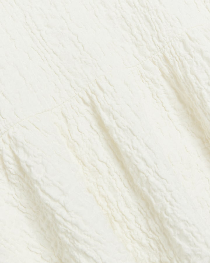 Cream textured peplum short sleeve top