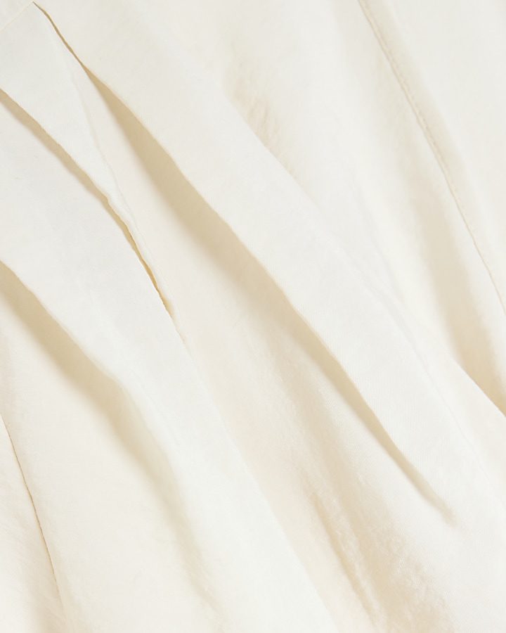 Cream belted long sleeve playsuit River Island