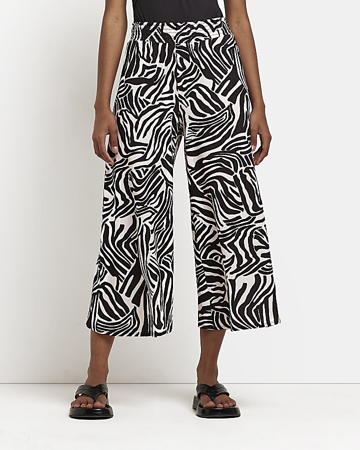 Black animal print wide leg cropped trousers