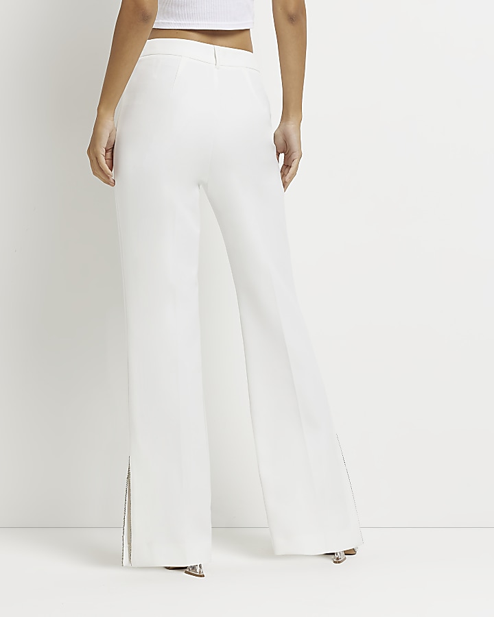 White embellished split hem trousers
