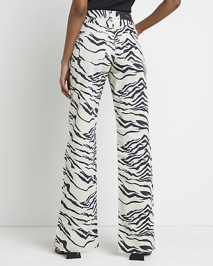 Ecru zebra print high waisted wide leg jeans | River Island