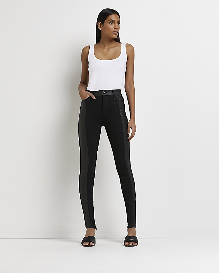 Black faux leather paneled skinny jeans