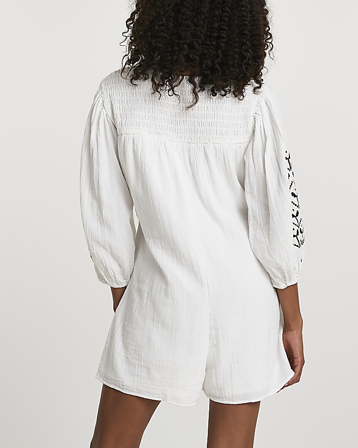 Cream long sleeve embroidered romper