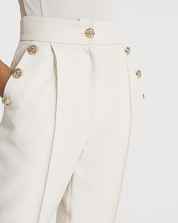 Cream button front peg trousers