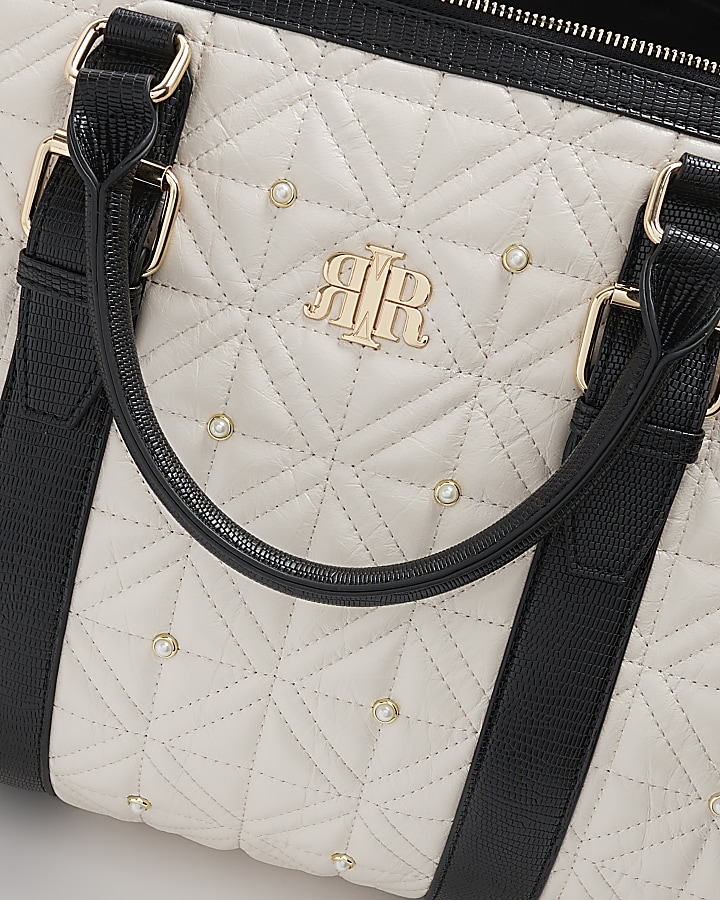 Cream quilted pearl travel bag