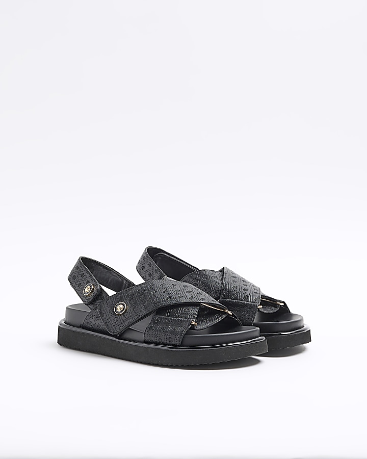 Black embossed crossed sandals