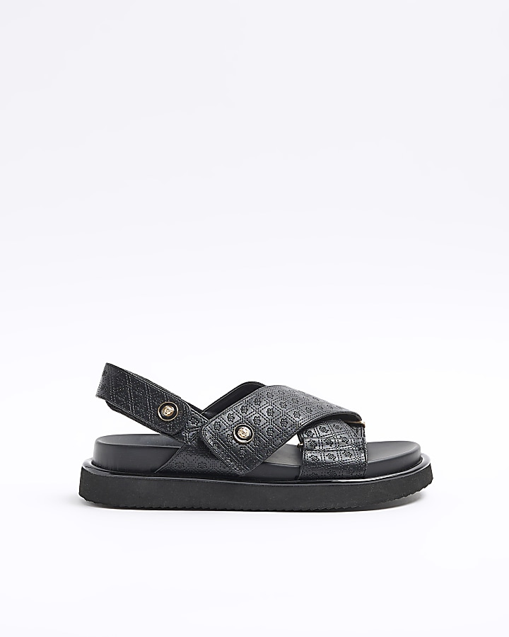 Black embossed crossed sandals