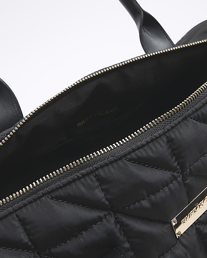 Black quilted travel bag River Island