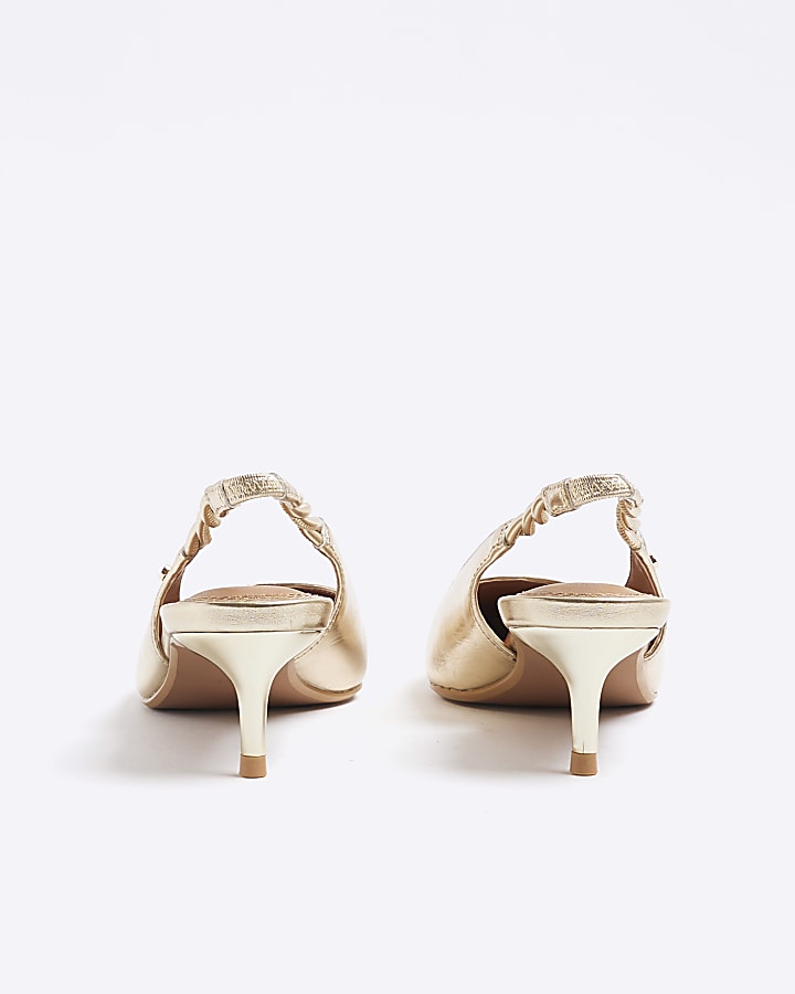 Gold sling back heeled court shoes