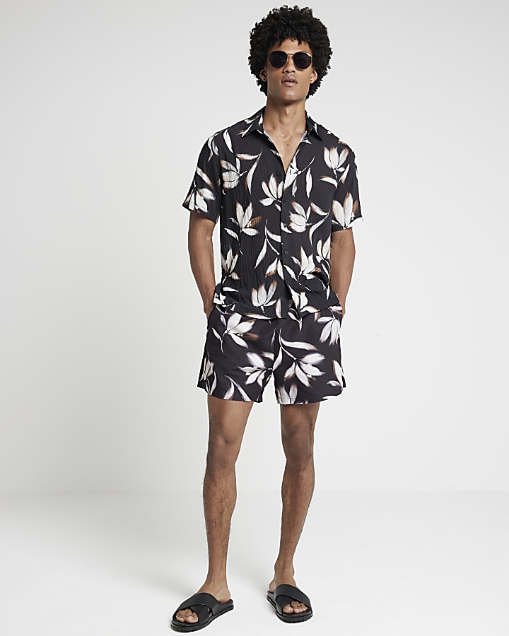 Black regular fit blur floral swim shorts