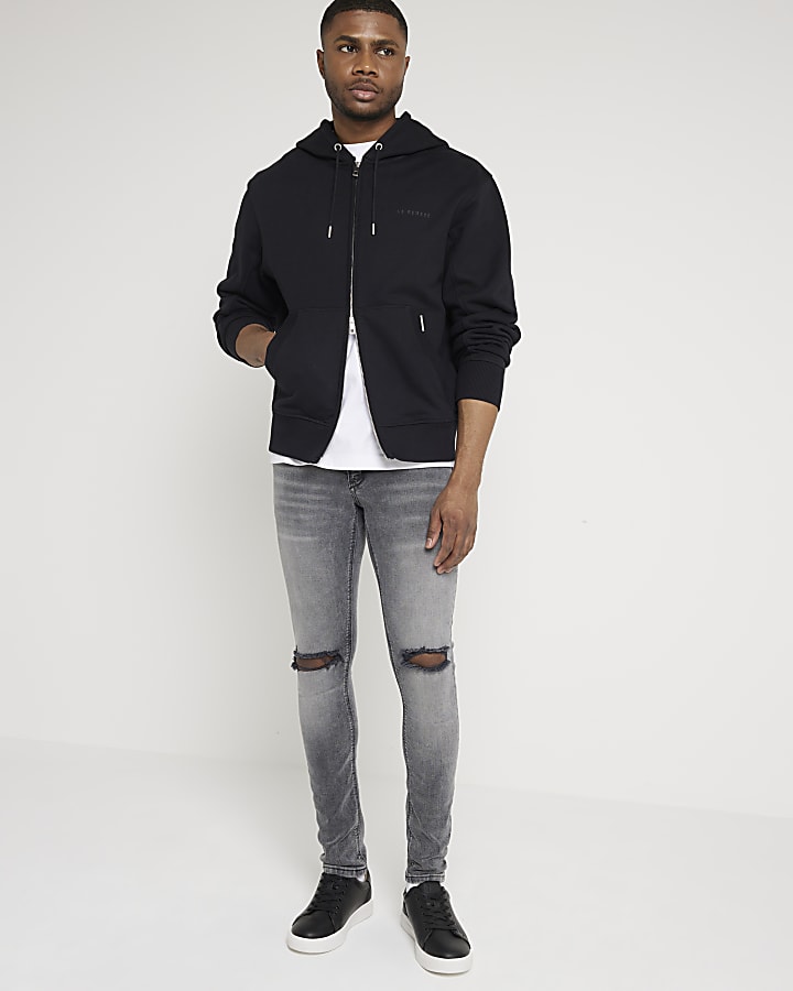 Washed black spray on skinny ripped jeans River Island