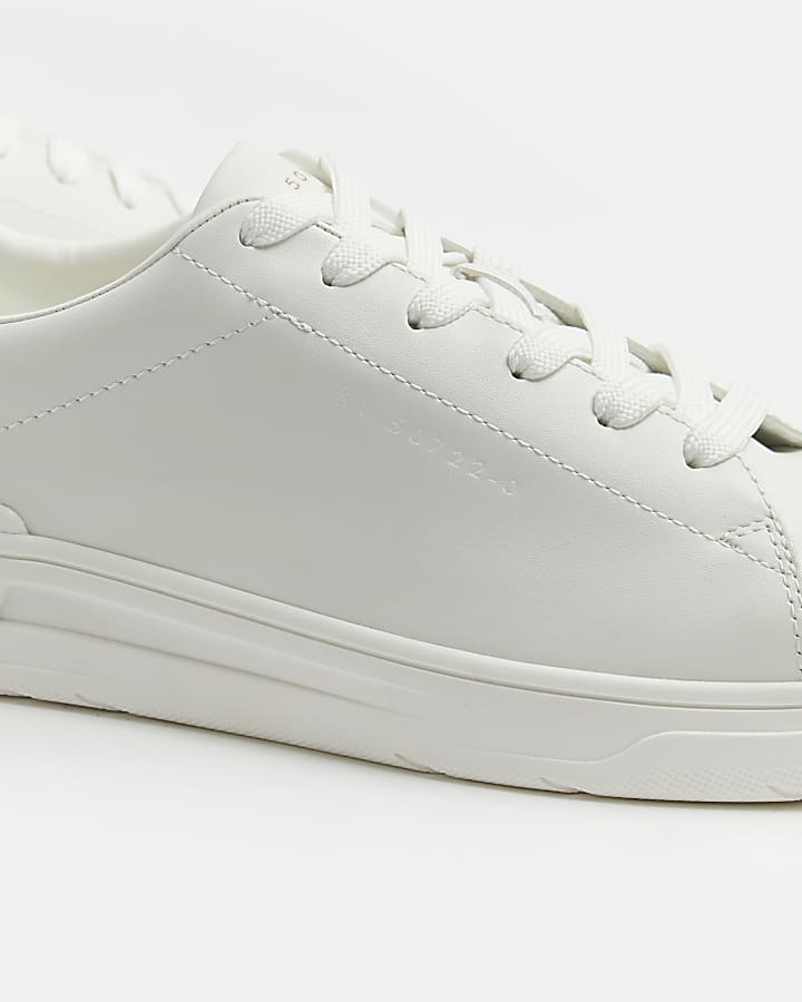 White lace up cupsole trainers
