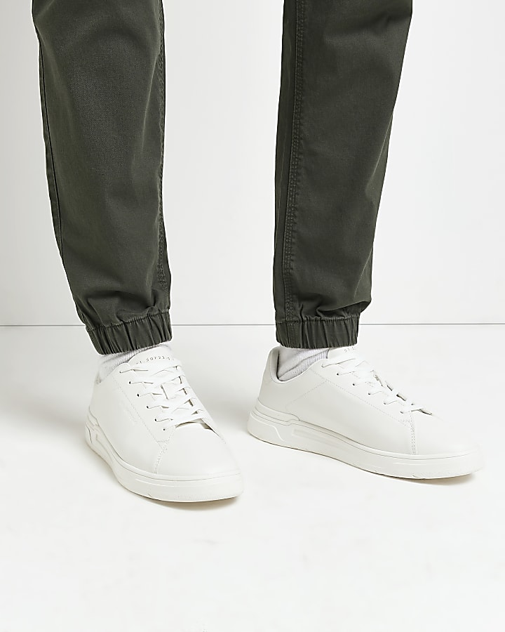 White lace up cupsole trainers