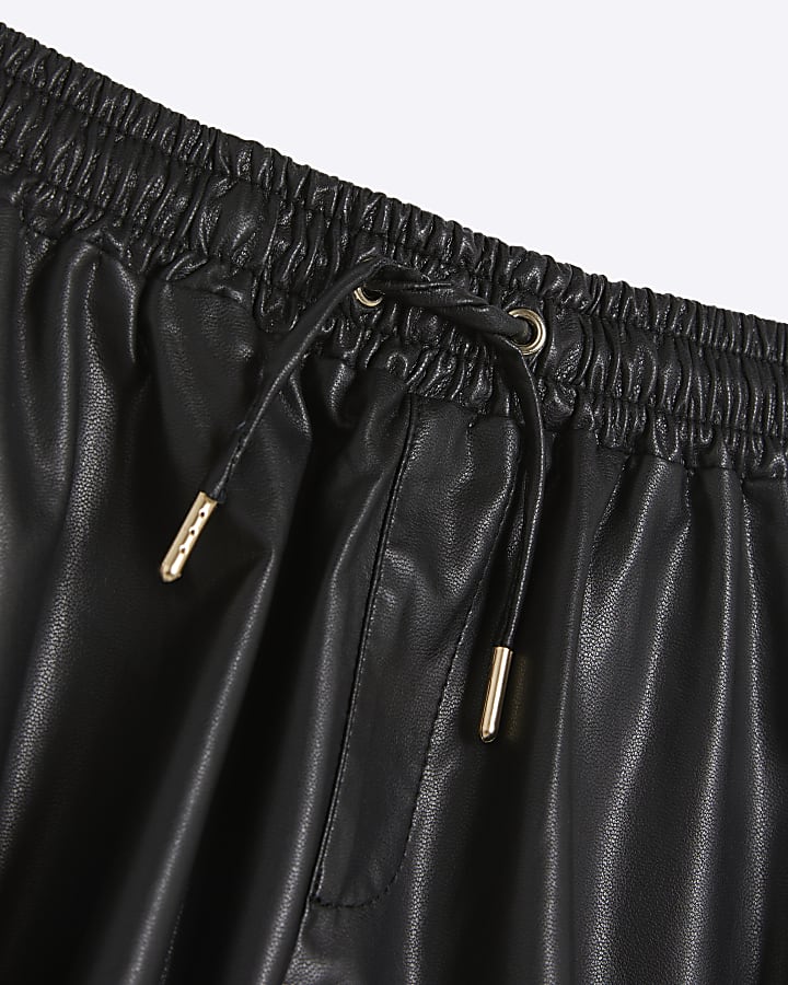 Girls black faux leather elasticated shorts