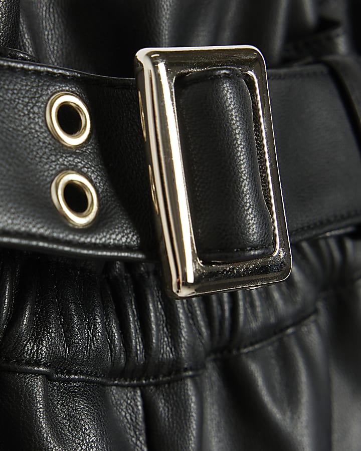 Girls black faux leather belted shorts