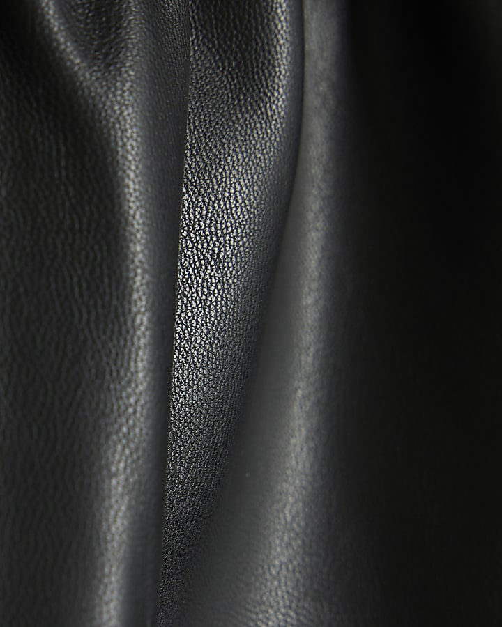 Girls black faux leather belted shorts
