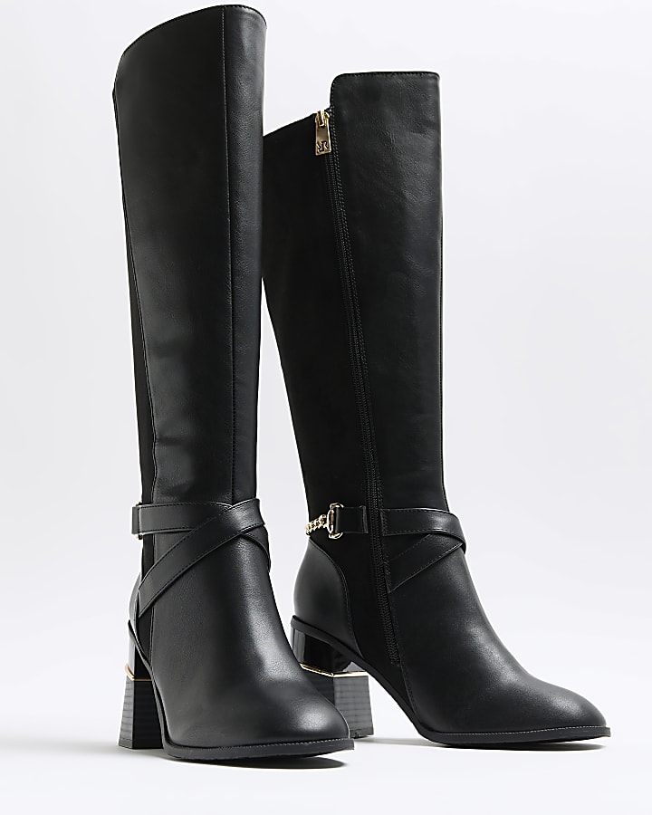 Black heeled high leg boots