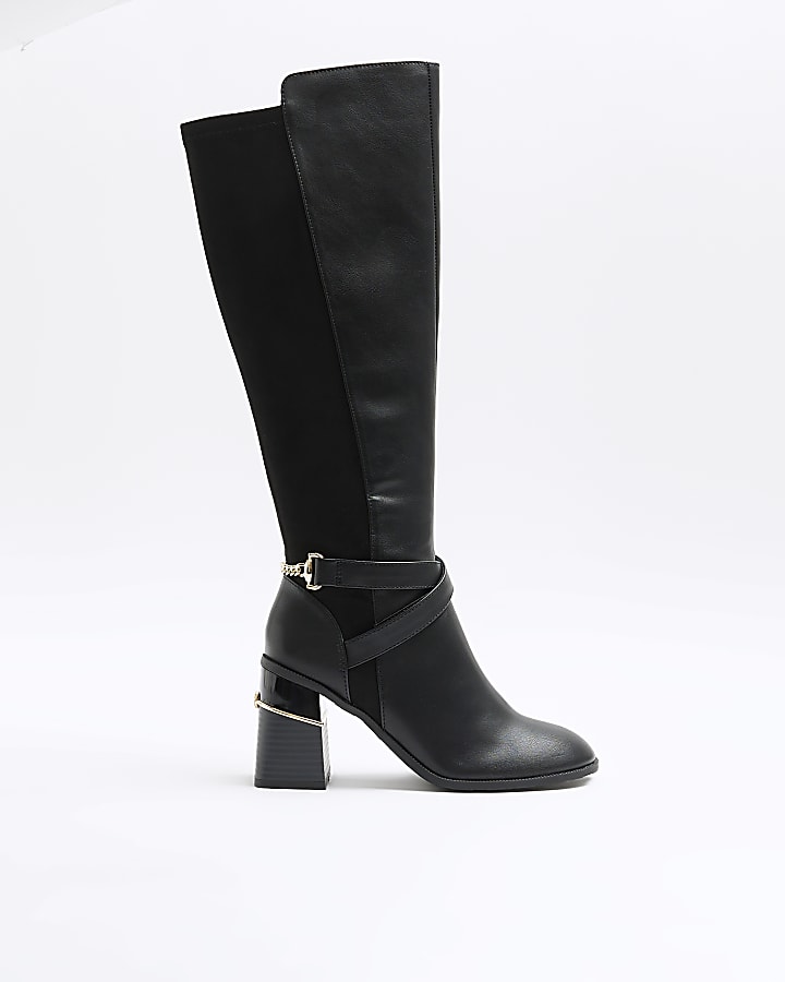 Black heeled high leg boots