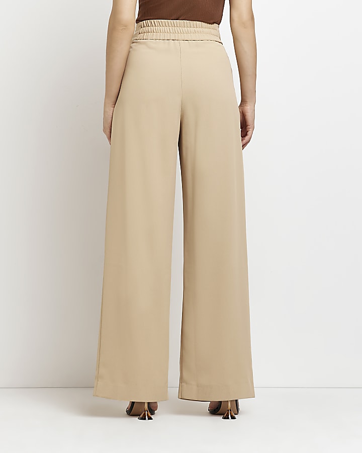 Beige pleated wide leg trousers