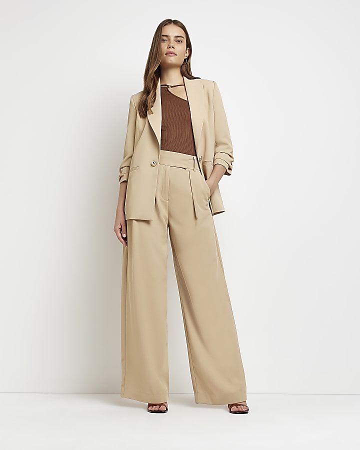 Beige pleated wide leg trousers