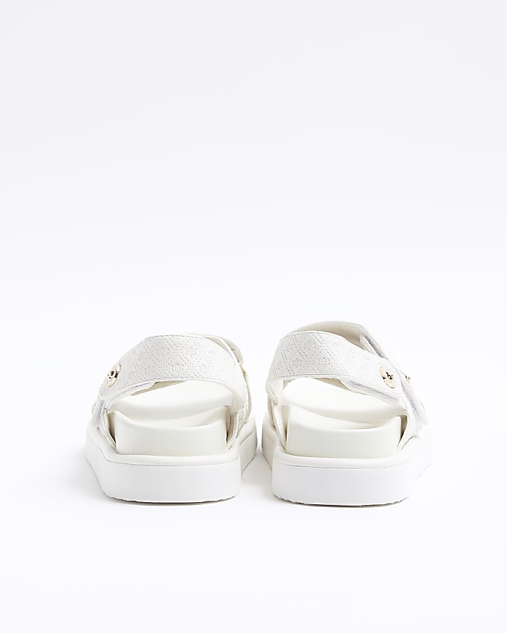 Beige embossed crossed sandals