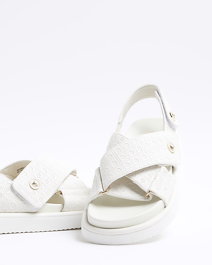 Beige embossed crossed sandals