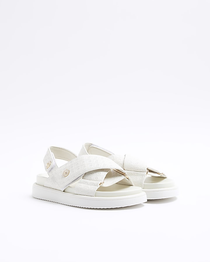 Beige embossed crossed sandals