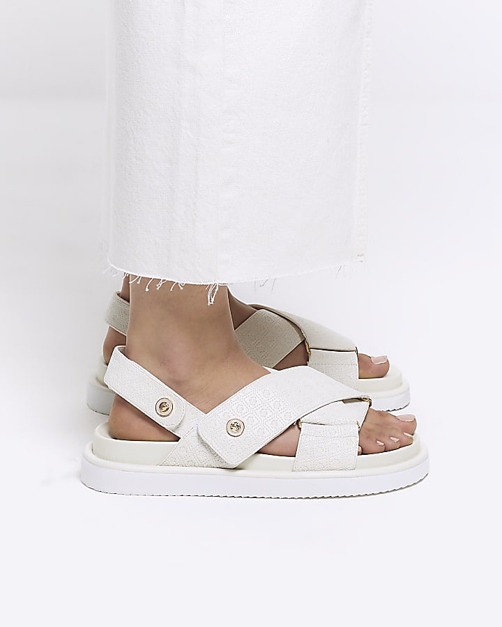 Beige embossed crossed sandals