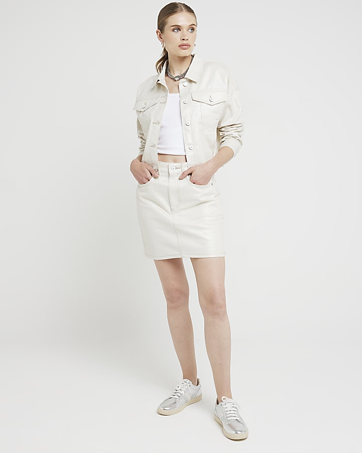 Beige metallic coated denim mini skirt