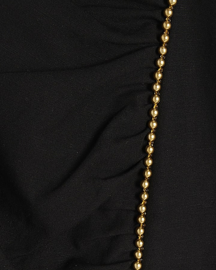 Black beaded peplum top