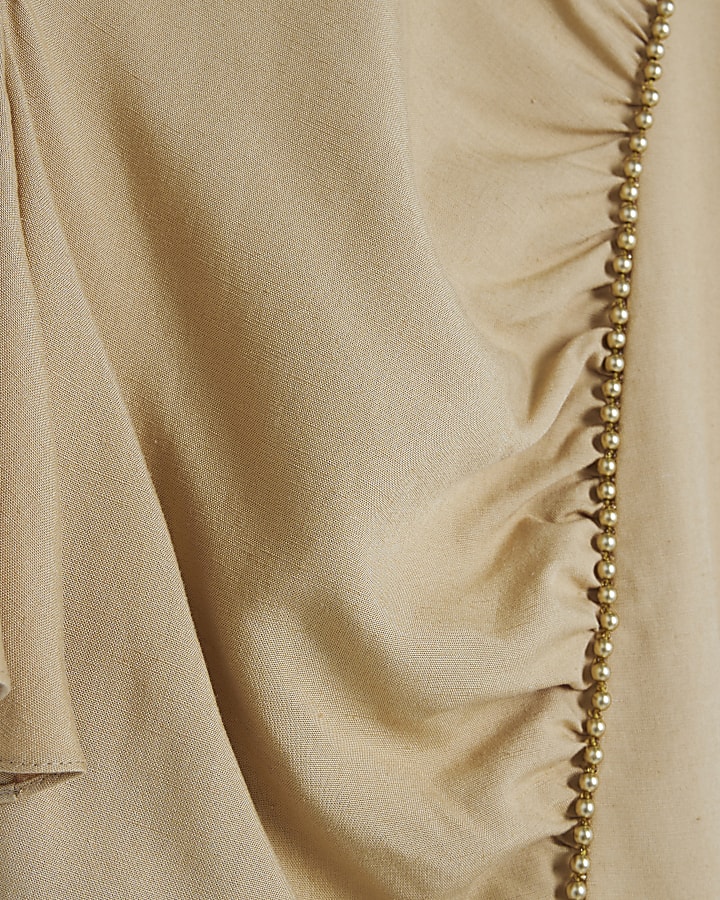 Beige beaded peplum top