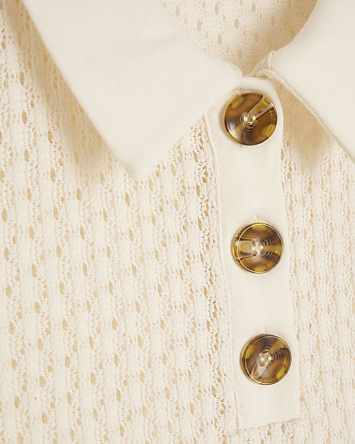 Cream sleeveless crochet polo top