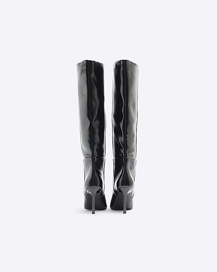 Black heeled high leg boots