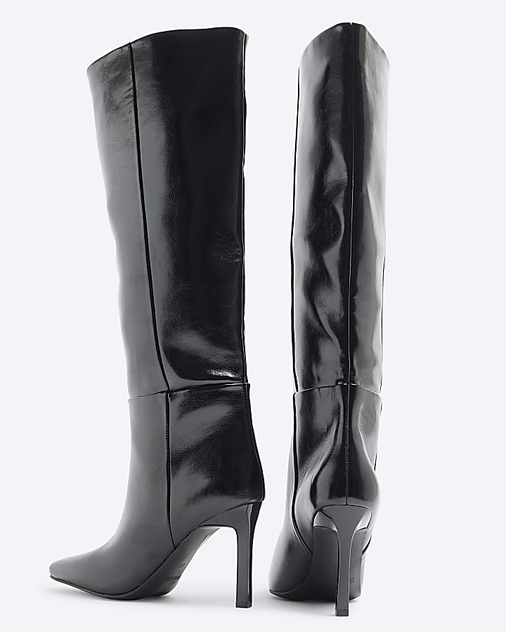 Black heeled high leg boots