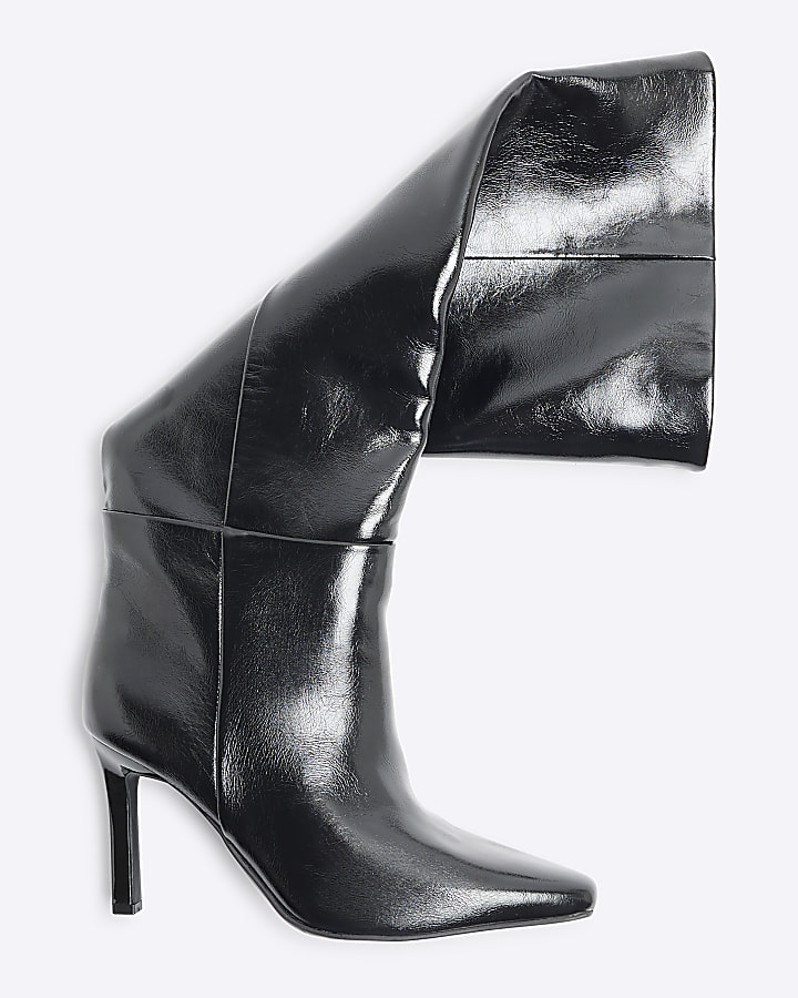 Black heeled high leg boots