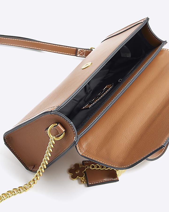 Brown charm cross body top handle bag