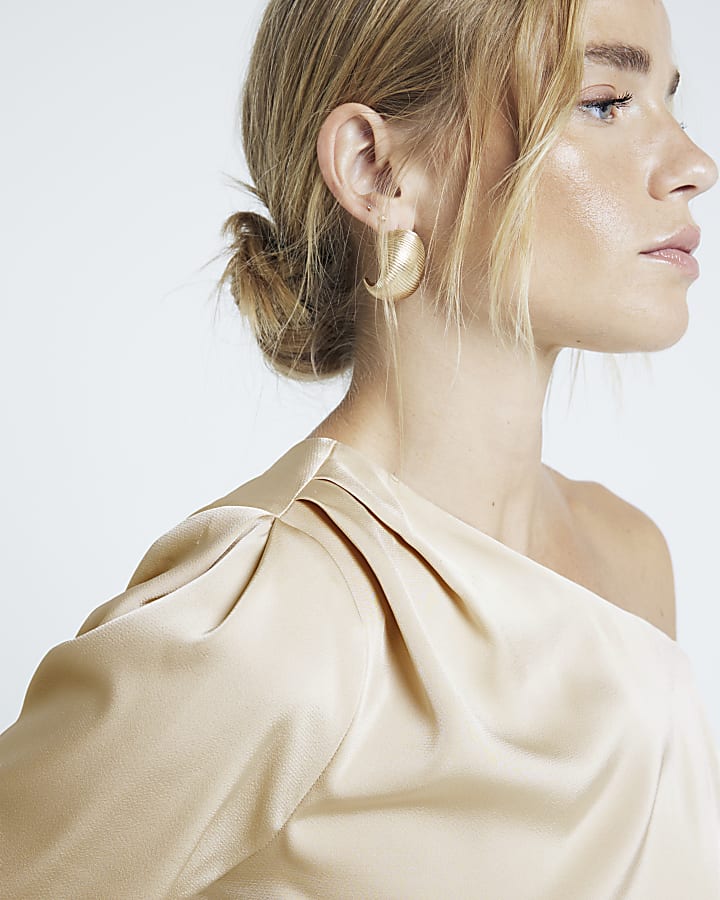 Cream one shoulder cuffed blouse